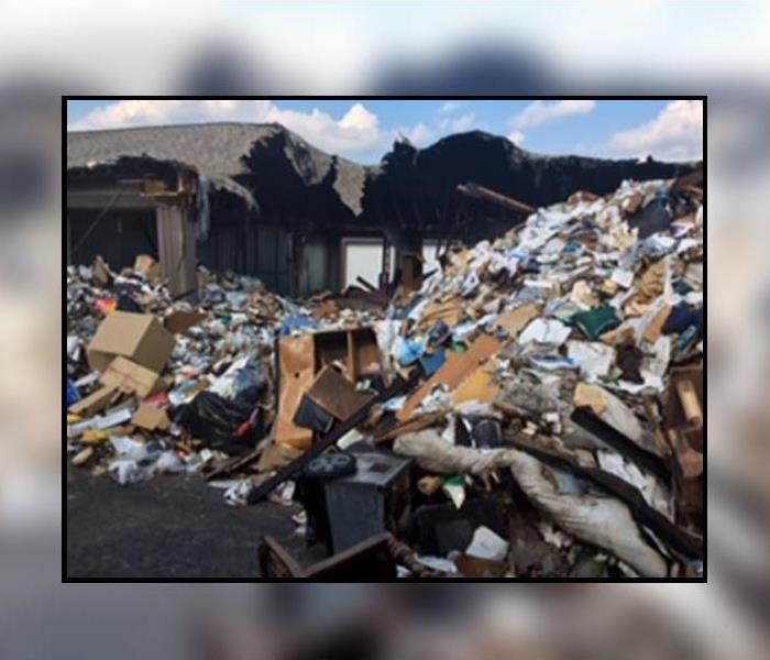 Fire damaged belongings left in a huge mound after a fire in storage unit