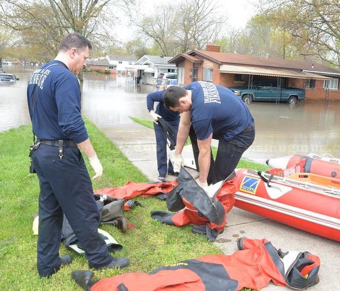 Firefighter putting on west suits to rescue people stranded by flood