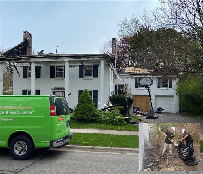 Servpro van parked in front of burn out historic home