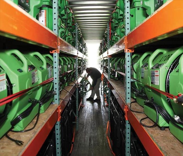 Stacks of equipment being inspected by a SERVPRO technician 