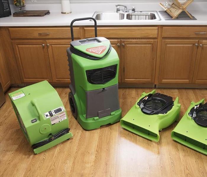 Image of Servpro water extraction tools in flooded kitchen
