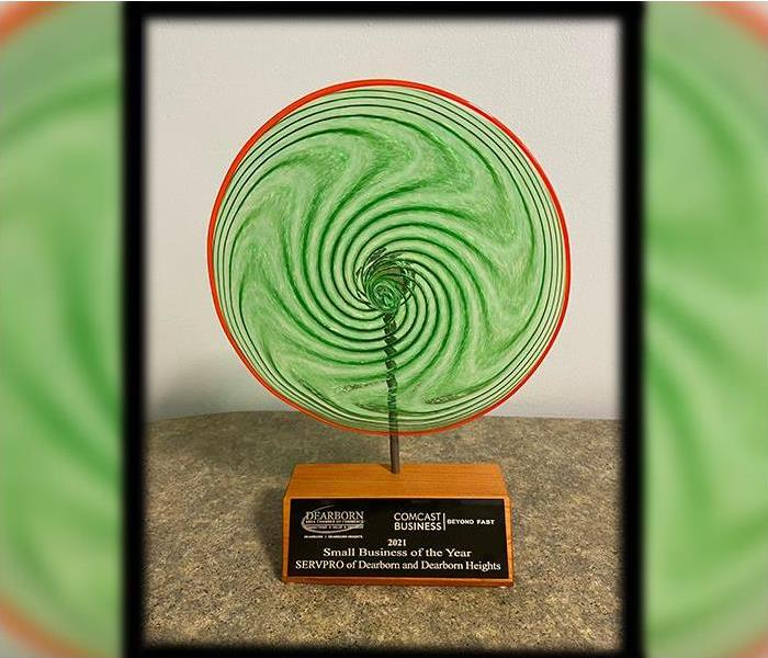 Award  of blown glass in Servpro green and Orange